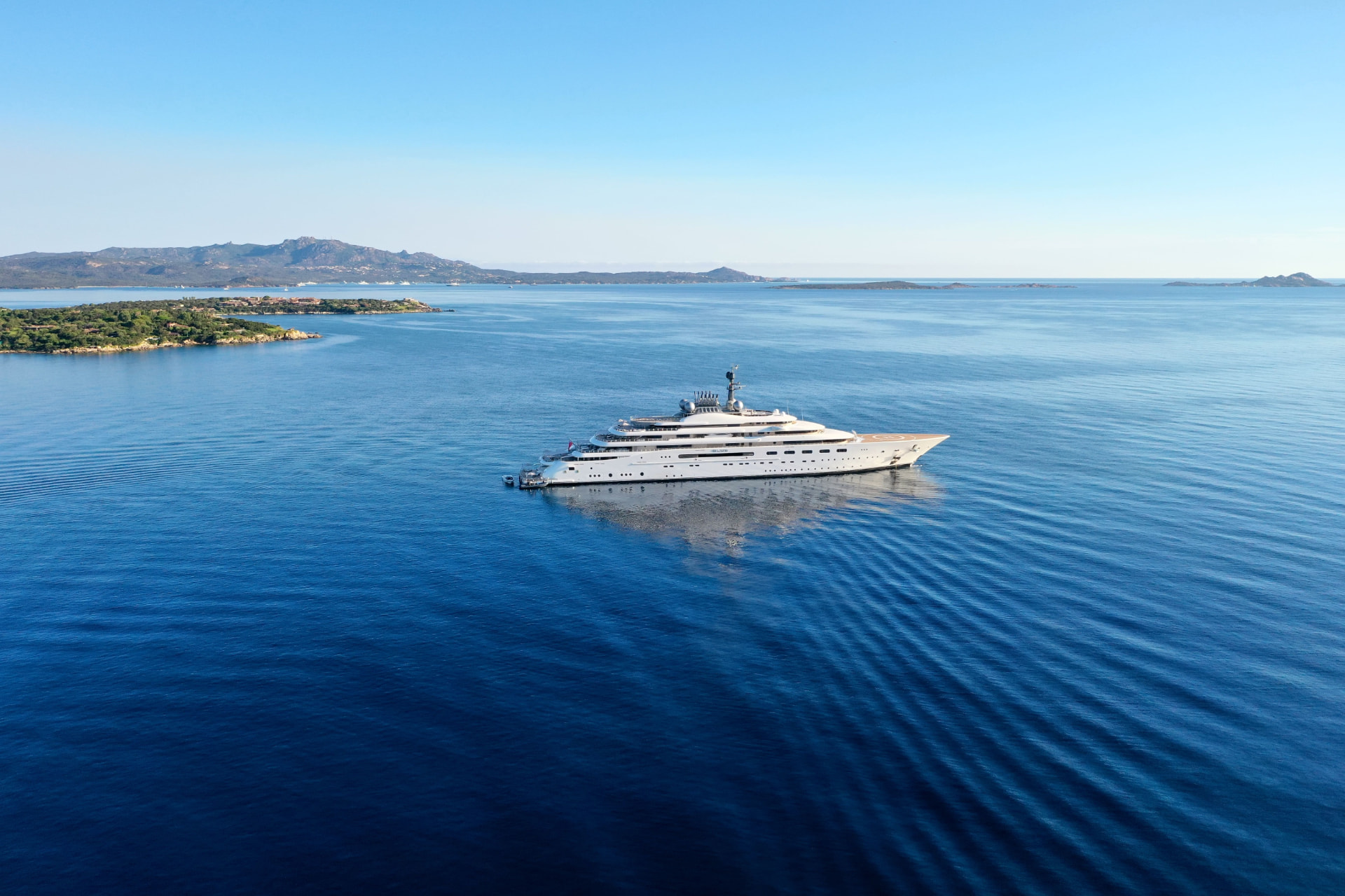 Superyacht under way on open Mediterranean sea in bright natural light